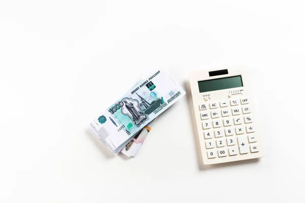 Top view of calculator near russian money on white — Stock Photo