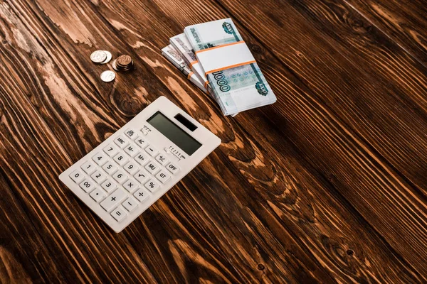Overhead view of calculator near russian money on wooden table — Stock Photo