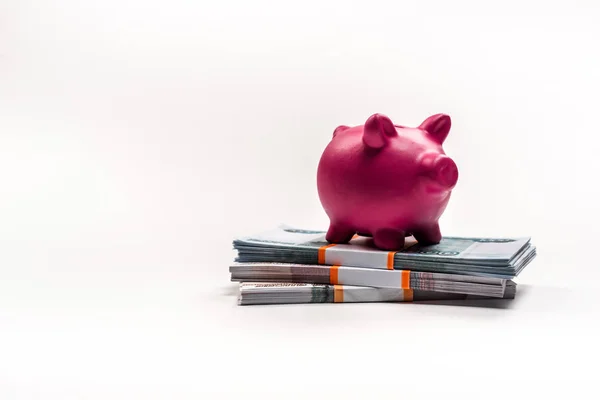 Pink piggy bank on stacks of russian money on white — Stock Photo