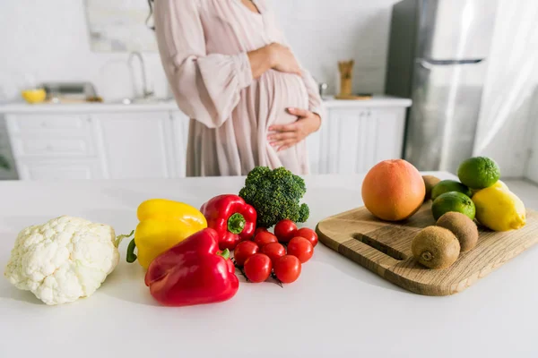 Cropped view of pregnant young woman touching belly — Stock Photo