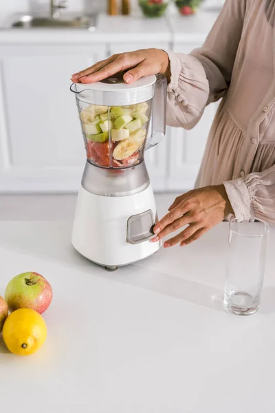 Cropped view of young pregnant woman touching button on blender — Stock Photo