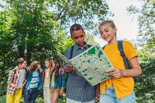 Selective focus of african american boy looking at map with friend — Stock Photo