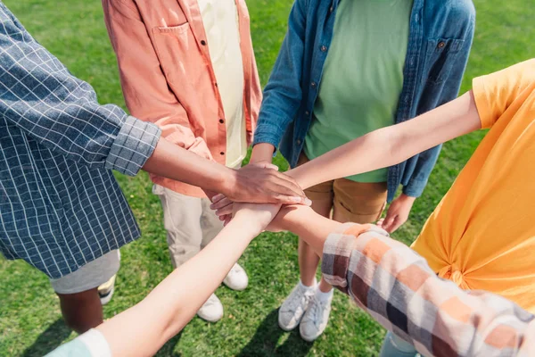 Vue recadrée des enfants multiculturels mettre la main ensemble — Photo de stock