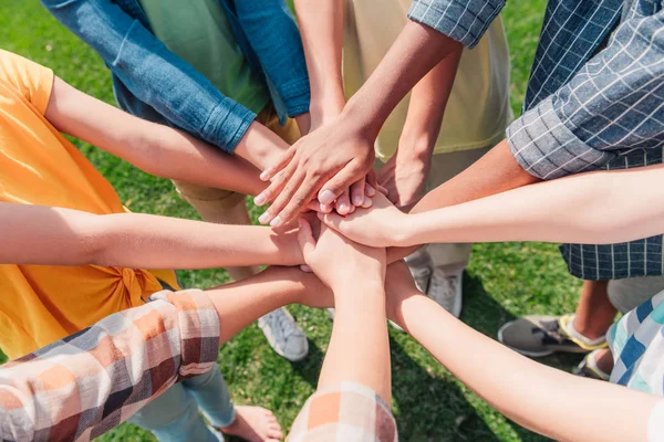 Cropped view of multicultural children putting hands together — Stock Photo