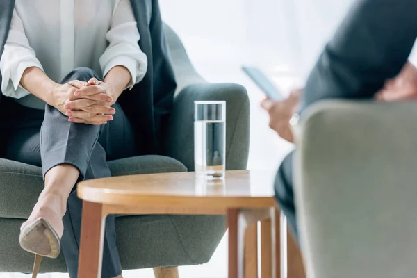 Cropped view of journalist and businessman in formal wear in office — Stock Photo