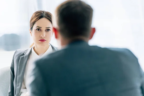 Selective focus of attractive journalist talking with businessman in suit — Stock Photo