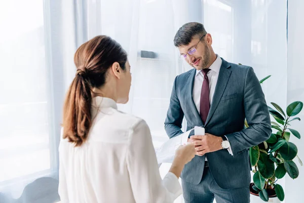 Back view of journalist talking with businessman in formal wear — Stock Photo