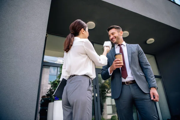 Journalist holding microphone and talking with businessman in formal wear — Stock Photo