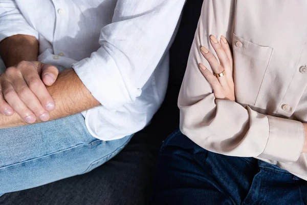 Partial view of woman and man with crossed arms — Stock Photo