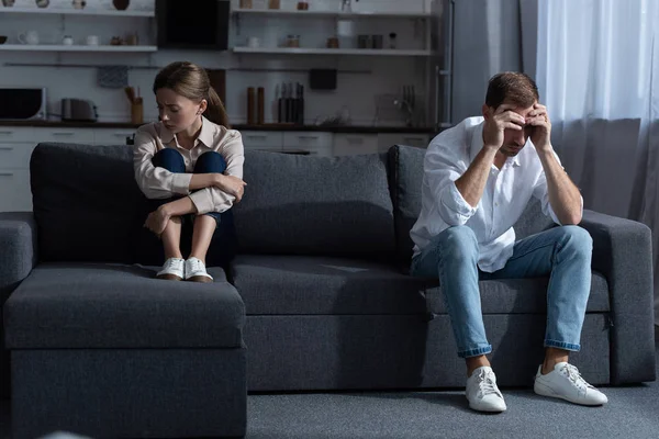 Pensive upset couple in living room at home — Stock Photo