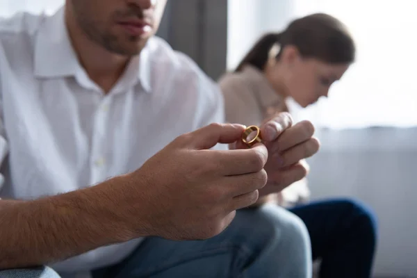 Cropped view of man holding ring in hands at home — Stock Photo