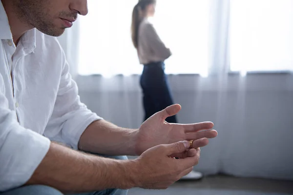 Partial view of man taking off ring and woman standing near window — Stock Photo