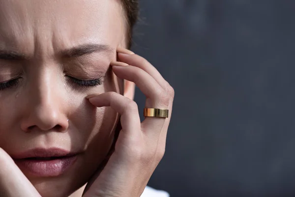 Partial view of upset young woman with ring with closed eyes — Stock Photo