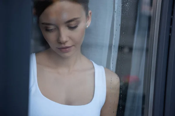 Selective focus of sad young woman looking down — Stock Photo