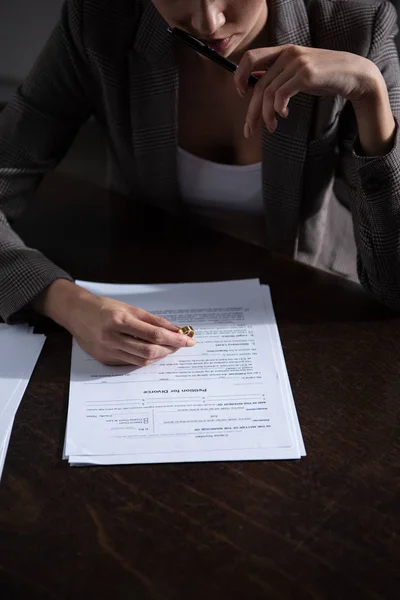 Partial view of woman in formal wear signing divorce documents — Stock Photo