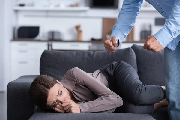 Partial view of man beating scared wife during quarrel — Stock Photo