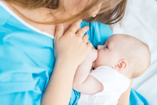 Vista recortada de la madre amamantando a su bebé en el hospital - foto de stock