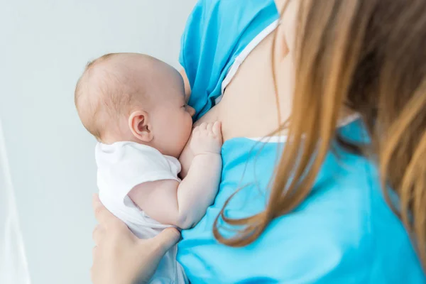 Cropped view of mother breastfeeding her baby in hospital — Stock Photo