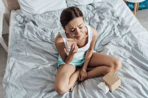 Overhead view of stressed young woman crying in bed — Stock Photo