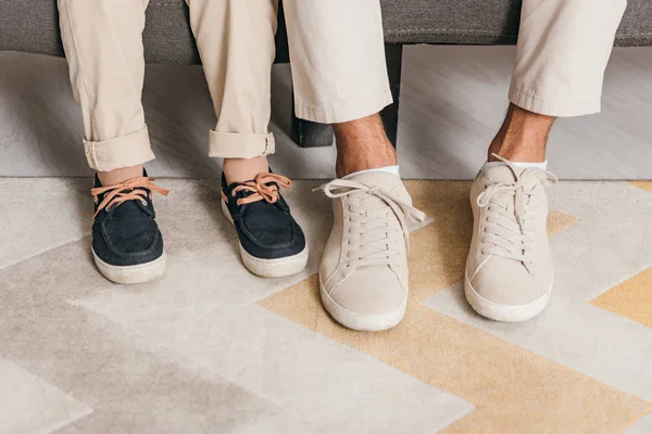 Partial view of father and son sitting on sofa — Stock Photo