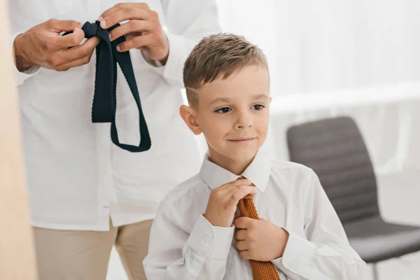 Partial view of dad and son in white shirts with ties — Stock Photo