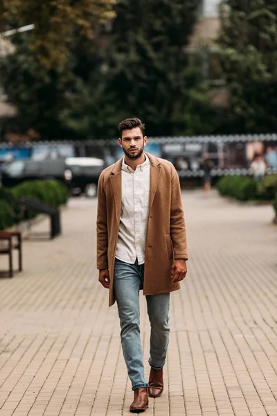 Full length view of handsome bearded man in stylish coat in autumn day on street — Stock Photo