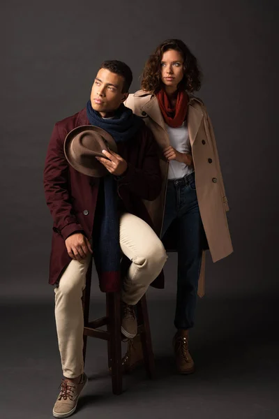 Elegant interracial couple in autumn outfit looking away — Stock Photo