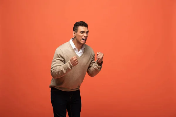 Mixed race man in beige sweater showing yes gesture isolated on orange — Stock Photo