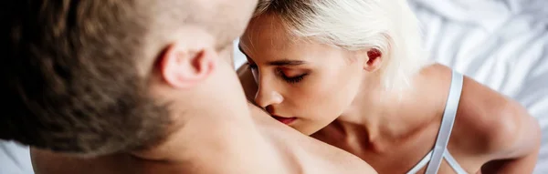 Panoramic shot of blonde and attractive woman kissing man — Stock Photo
