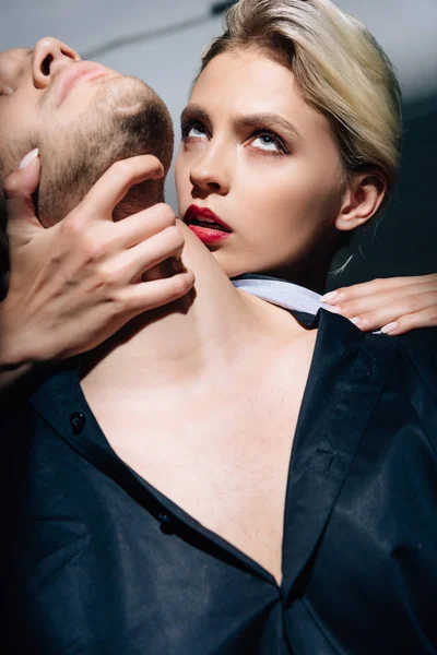 Attractive woman in black underwear hugging man in shirt — Stock Photo