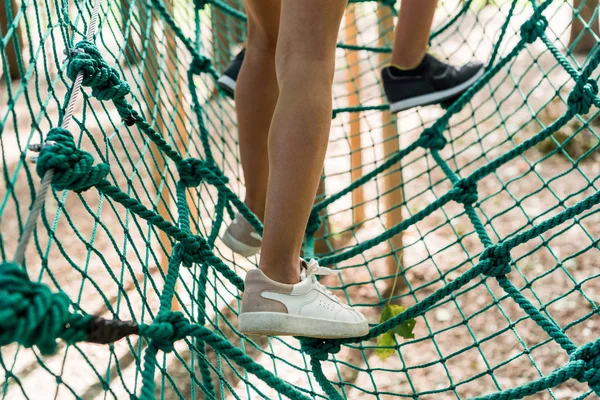 Cropped view of kids standing on high rope trail — Stock Photo