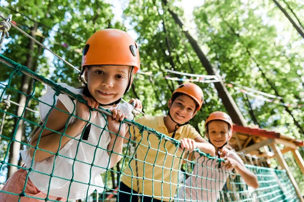 Selective focus of cute kid near adorable friends in helmets — Stock Photo