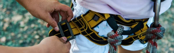 Tiro panorâmico de criança tocando equipamentos de segurança perto de amigo — Fotografia de Stock