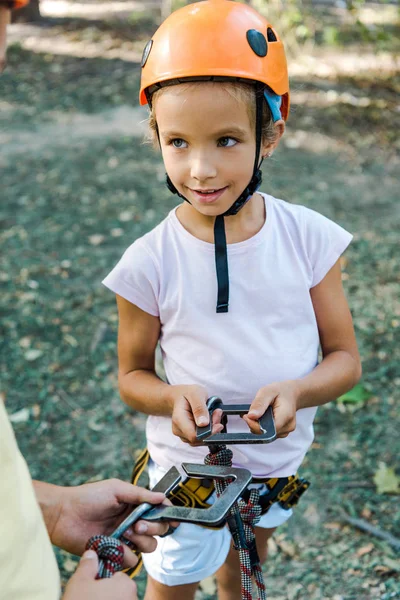 Cropped view of boy near cute friend holding safety equipment — Stock Photo