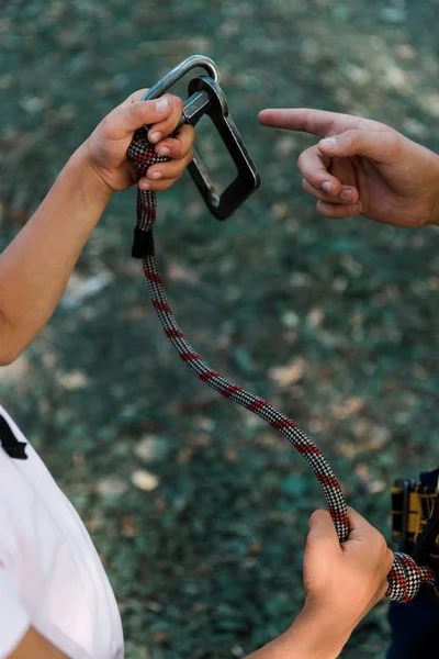 Cropped view of kid pointing with finger at safety equipment — Stock Photo