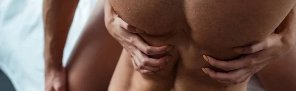 Plan panoramique de jeune femme touchant homme torse nu — Photo de stock
