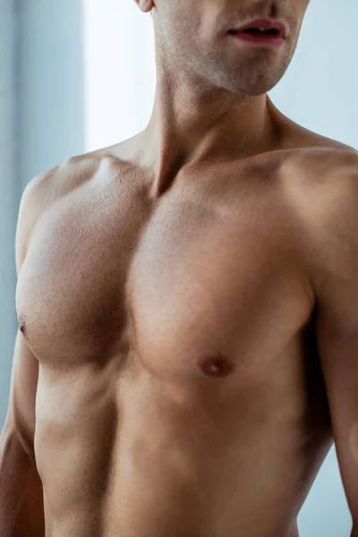 Cropped view of shirtless man standing at home — Stock Photo