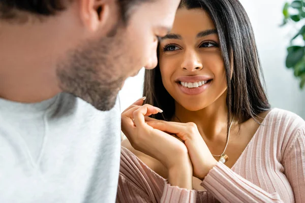 Selective focus of smiling african american woman looking at her boyfriend — Stock Photo