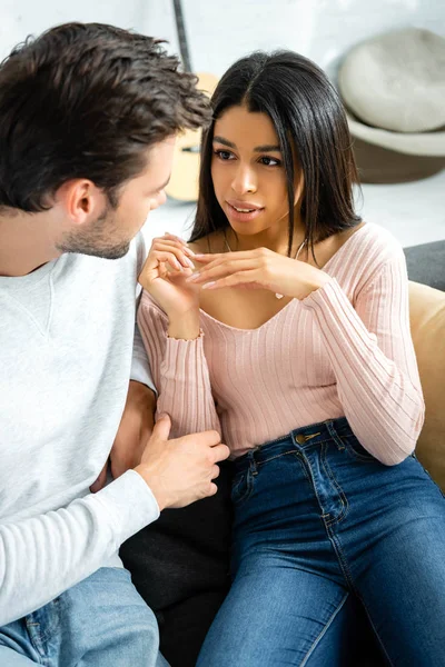 Attractive african american woman looking at her boyfriend in apartment — Stock Photo