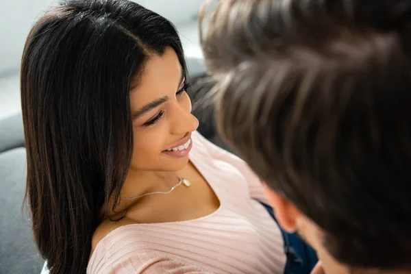 Selective focus of attractive and smiling african american woman looking at man — Stock Photo