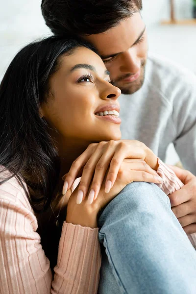 African american woman and handsome man smiling and hugging in apartment — Stock Photo