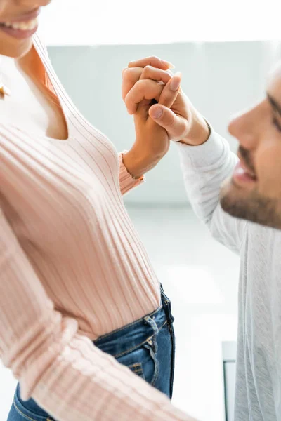 Cropped view of african american woman and man holding hands — Stock Photo