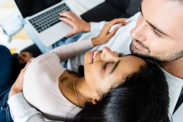 High angle view of smiling african american woman and handsome man with laptop — Stock Photo