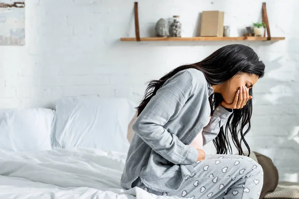 Pregnant african american woman having toxicosis vomit in apartment — Stock Photo