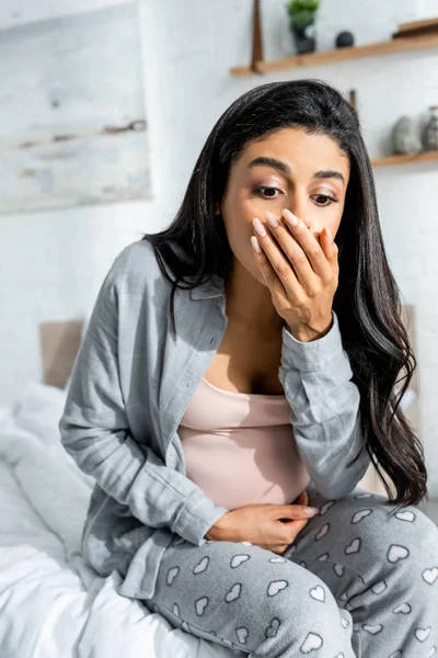 Pregnant african american woman having toxicosis vomit in apartment — Stock Photo