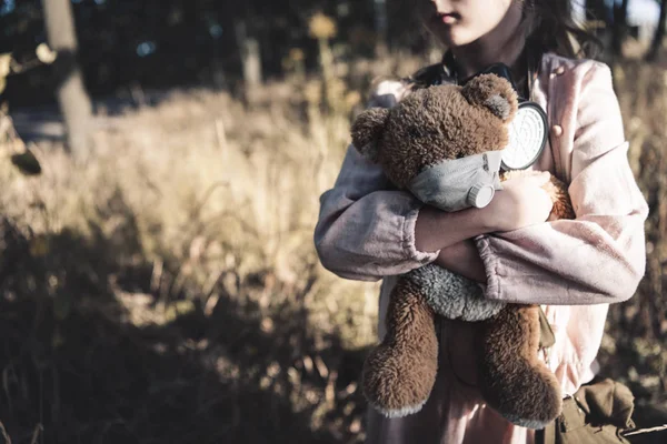 Cropped view of dirty kid holding teddy bear in chernobyl, post apocalyptic concept — Stock Photo