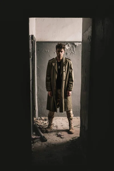 Handsome man standing in old room in chernobyl, post apocalyptic concept — Stock Photo