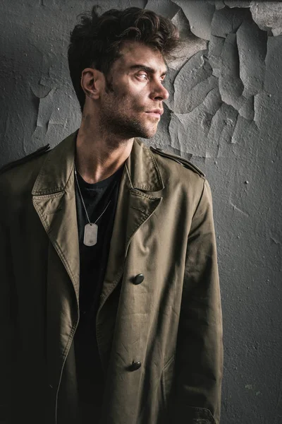 Handsome man standing near old wall in chernobyl, post apocalyptic concept — Stock Photo