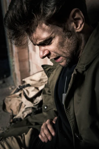 Handsome man with dirty face suffering pain, post apocalyptic concept — Stock Photo