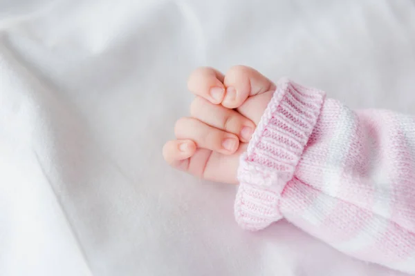 Cropped view of baby lying on bed — Stock Photo